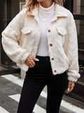 Ivory white women's double-sided plush button cardigan on a hanger.