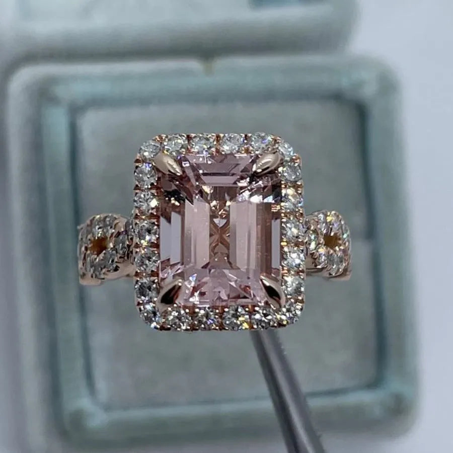 Geometric rose gold coloured alloy ring on a plain background.