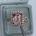 Geometric rose gold coloured alloy ring on a plain background.