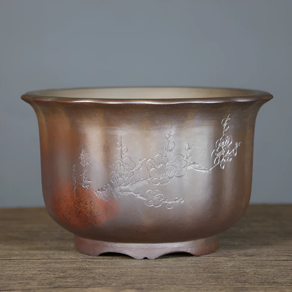 Large antique carved ceramic flower pot in purple sand clay with classical styling for indoor plants
