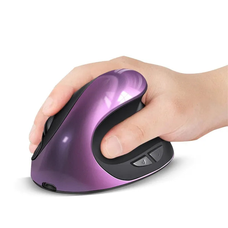 Wireless vertical ergonomic mouse in red colour on a desk next to a laptop.