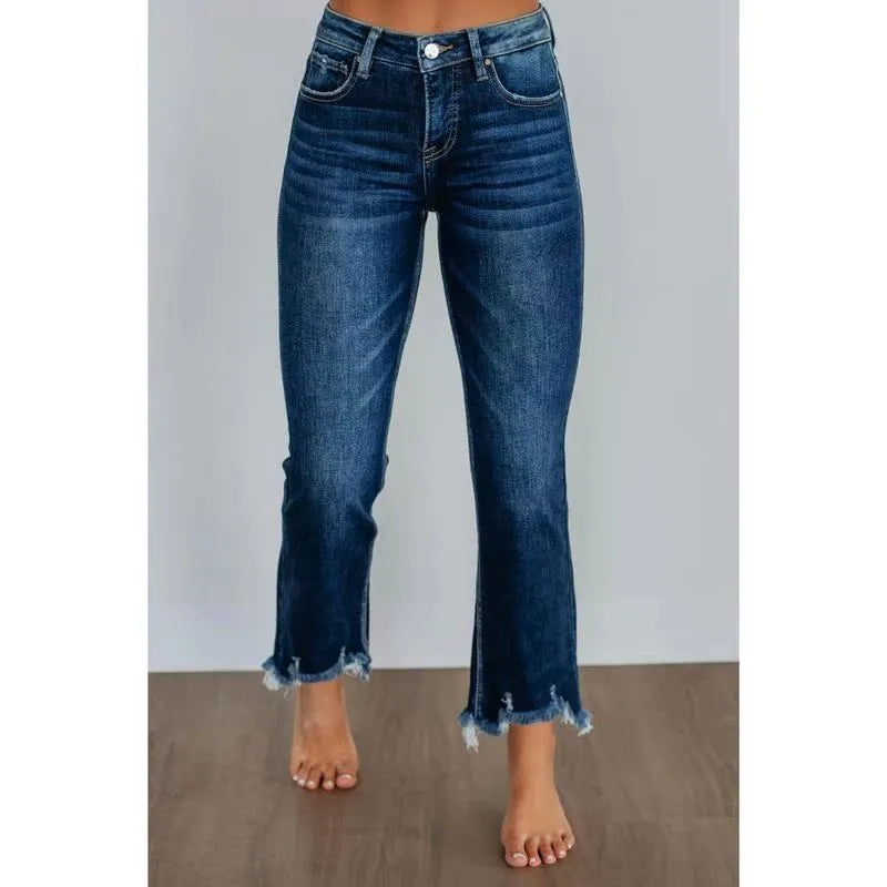 Women's dark blue casual denim jeans with hand-worn distressing on a solid cotton fabric