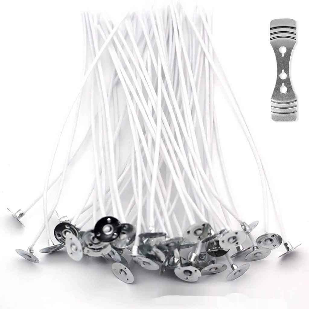 Close-up of white cotton candle wicks in three lengths: 2.6cm, 6cm, and 8cm.