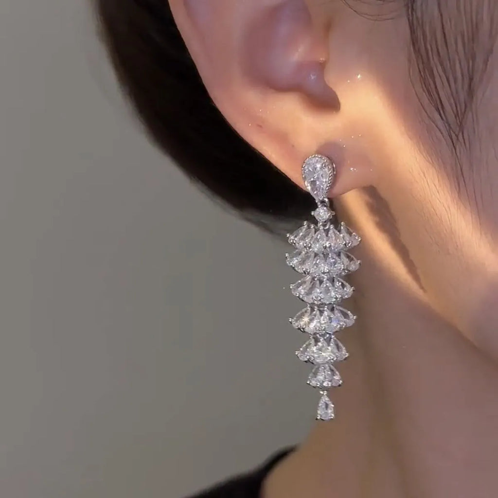 Silver Pagoda colour Christmas tree shaped drop earrings with stud fastenings and sparkling zircon finish.