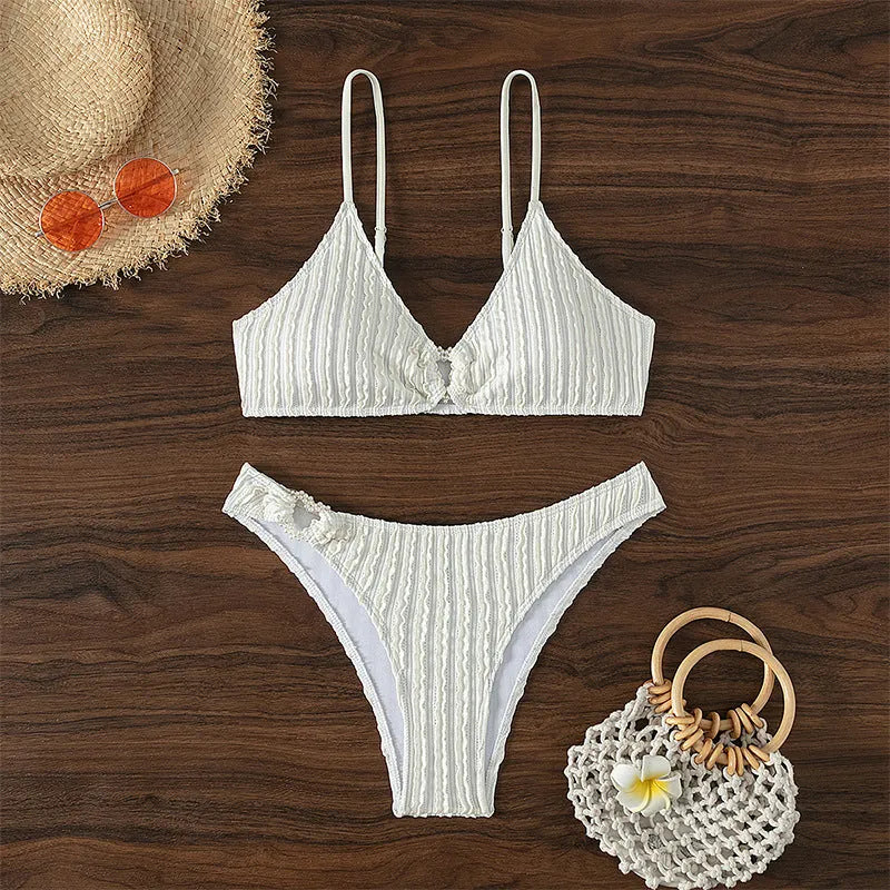 White women's V-neck sleeveless swimsuit top with matching split hem shorts.