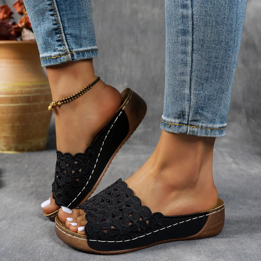 Women's wedge beach slippers with flower cutout design in PVC material showing fish mouth toe shape