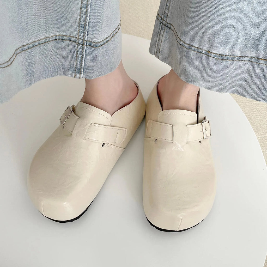 Flat buckle casual sneakers in yellow, creamy-white, silver, and black colours on a white background.