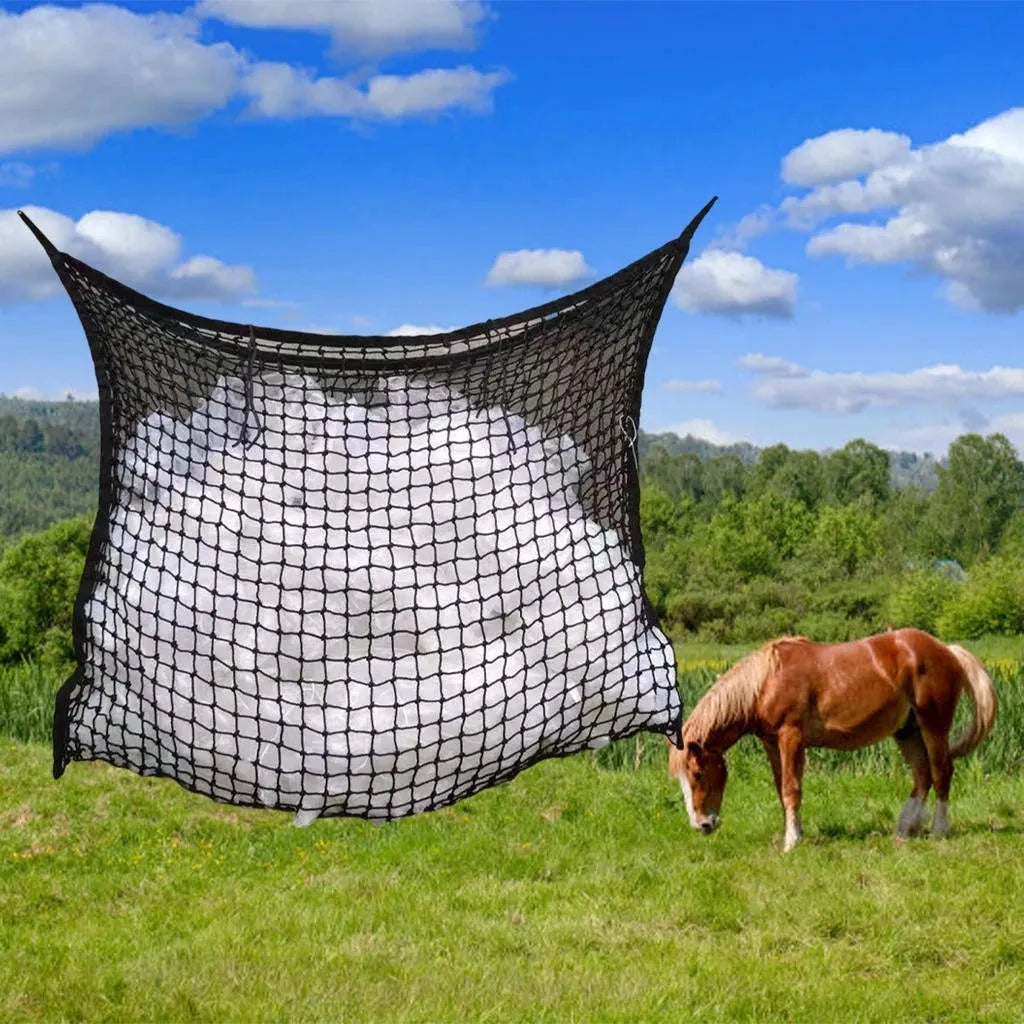 Black woven PE rope horse feeding bag with grid design hanging in stable