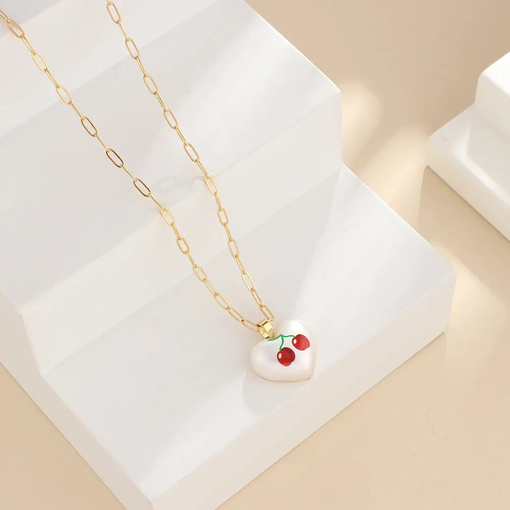 Geometric fruit pendant necklace on an adjustable chain, showing apple, cherry, pear, pineapple, and strawberry charm options.
