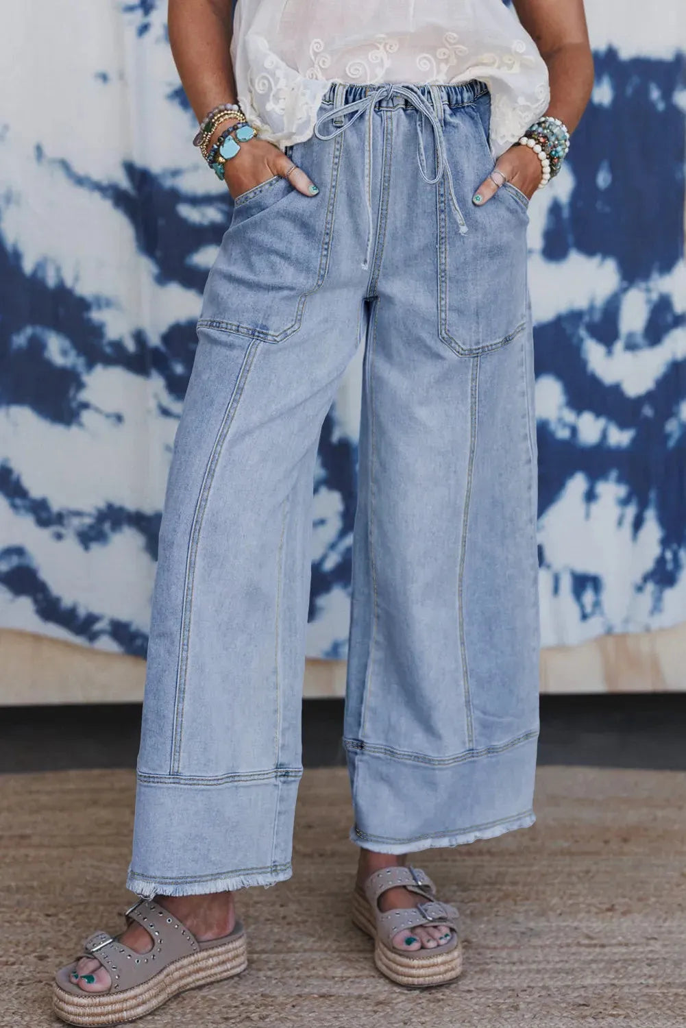 Beau blue wide leg denim trousers with drawstring waist and raw hem detail