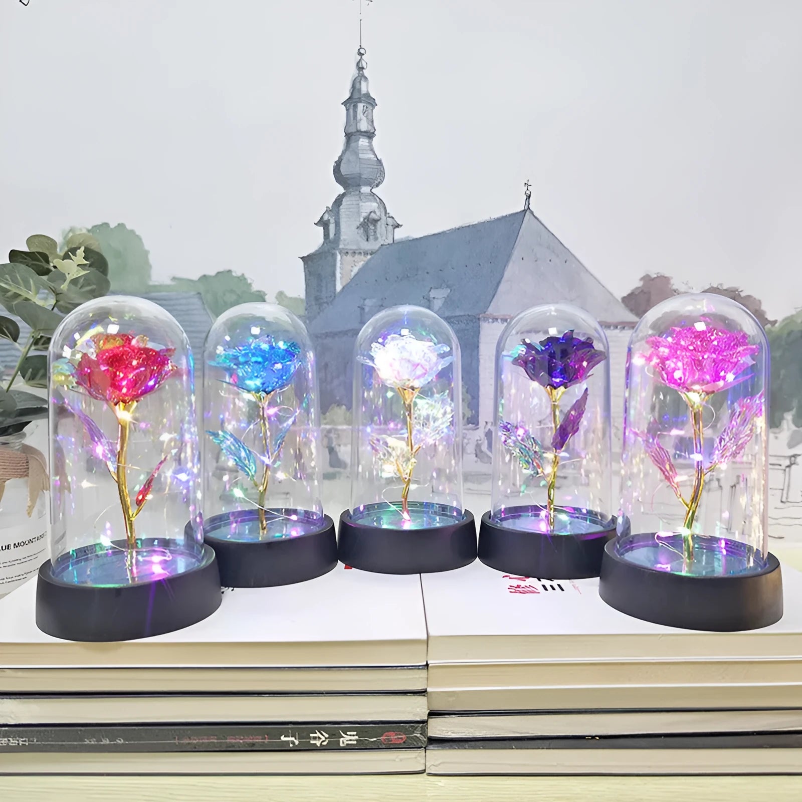 Small decorative night lamp with glass cover and plastic flowers, showing coloured light illumination.