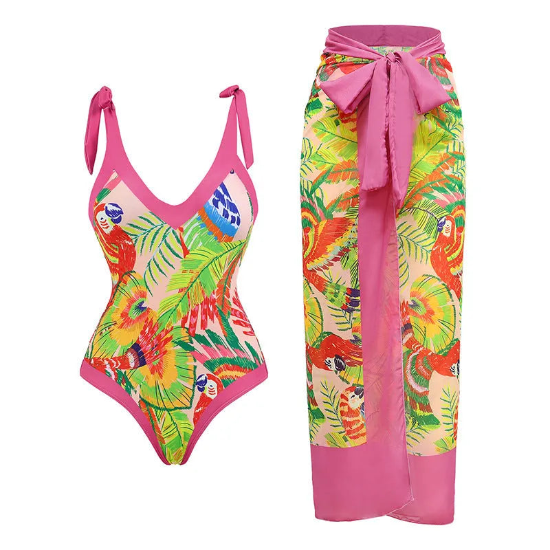 Pink floral print women's V-neck one-piece swimsuit with a thin skirt.
