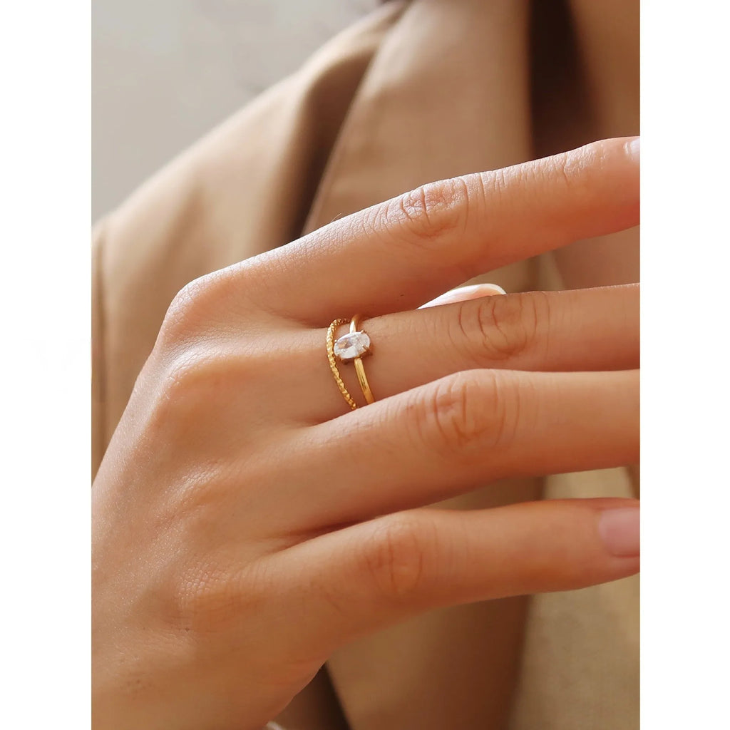 Golden stainless steel ring with love heart and oval designs showing electroplated finish and simple bracelet style