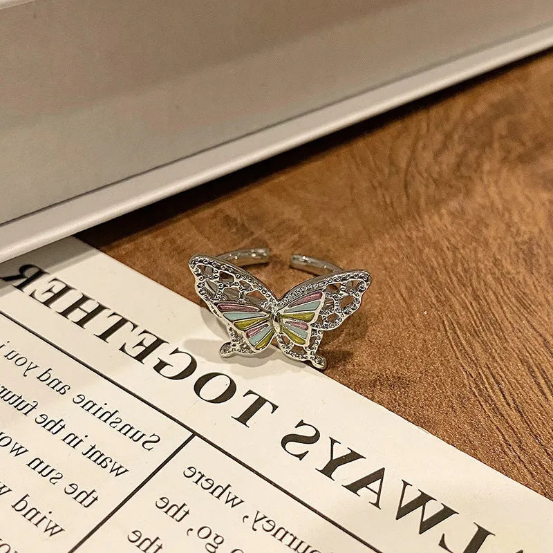 Copper butterfly women's ring with drip oil finish in an open-loop design.