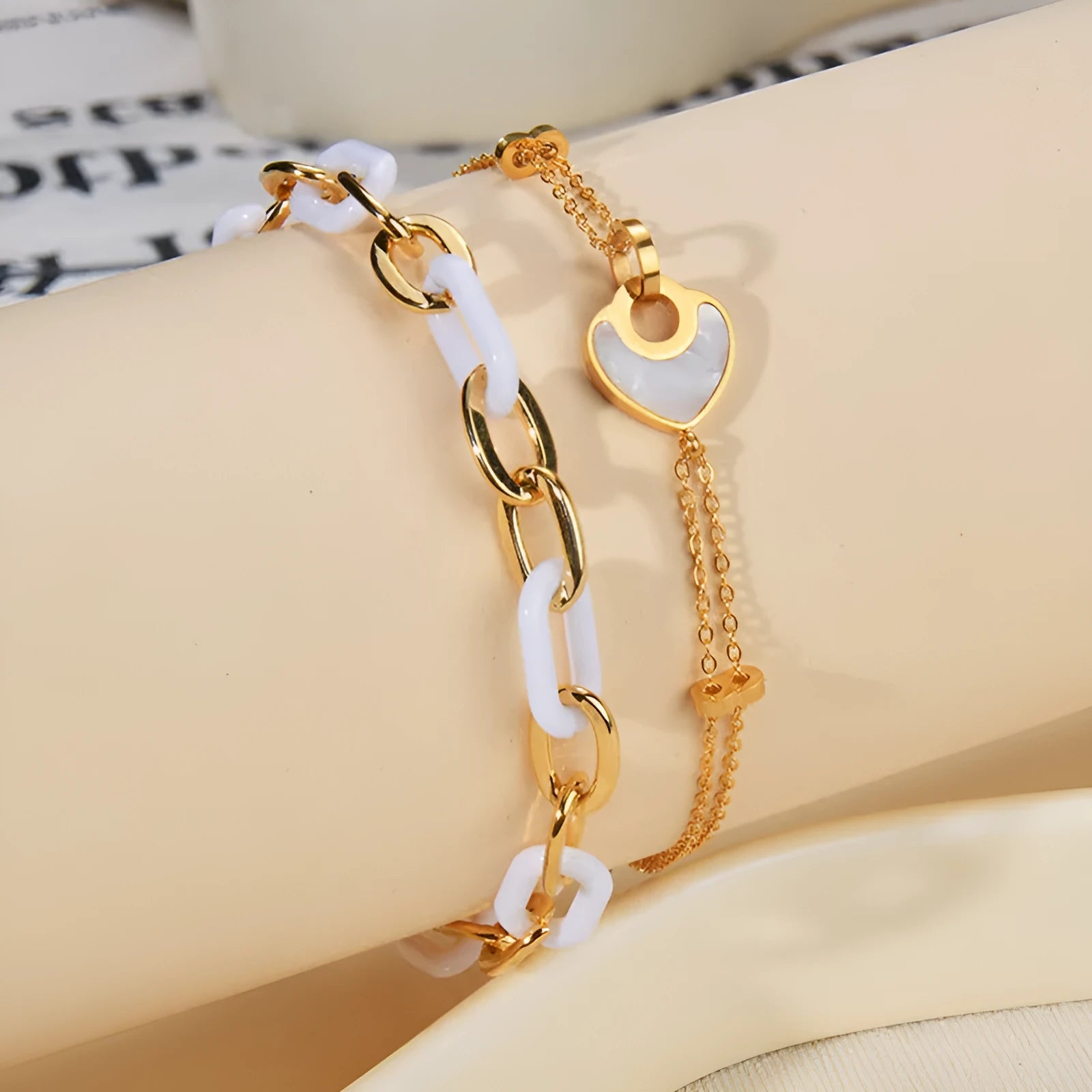 Women's stainless steel bracelet with electroplated finish and a double-layered resin heart charm.