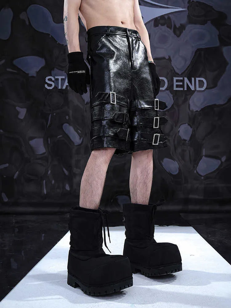 Men's black PU leather casual shorts with cropped length and a leather ring detail on the front.
