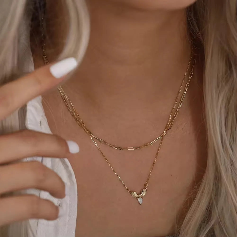 Sterling silver eagle pendant necklace with an O-ring chain on a model, showing white gold colour finish.