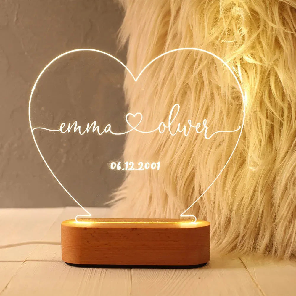 Custom couple names and date engraved on a transparent acrylic LED night light.
