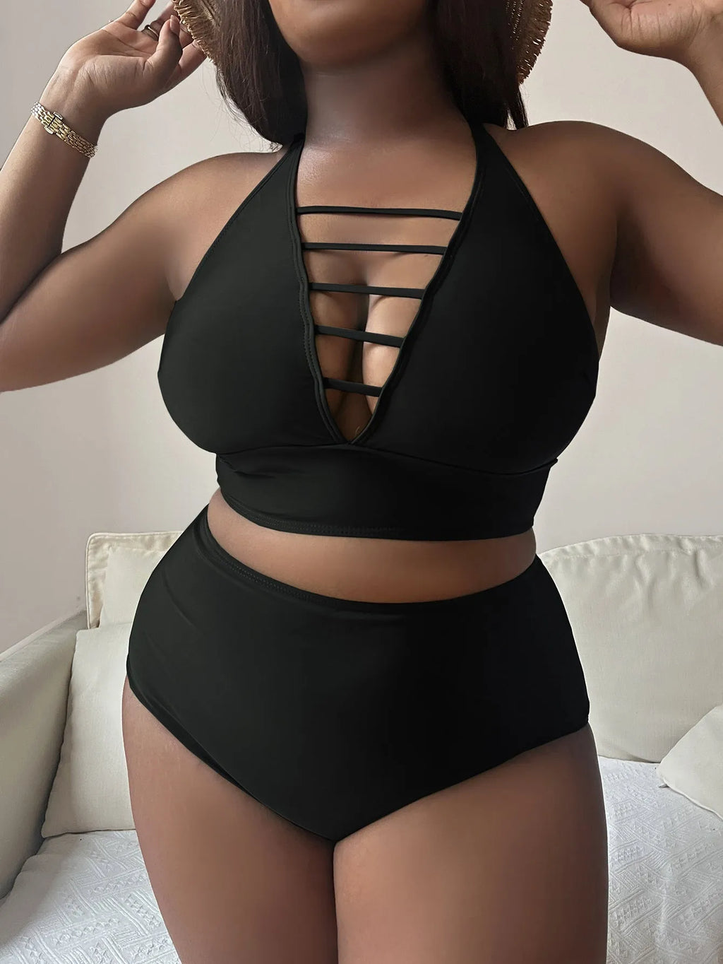 Plus size woman modelling a solid colour halter bikini with adjustable cross straps and high waist briefs.