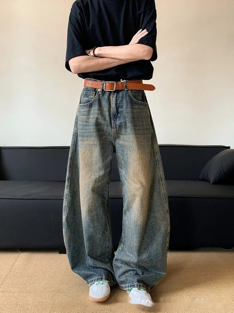 Men's retro blue distressed denim jeans with slim wide-leg cut and micro stretch fabric