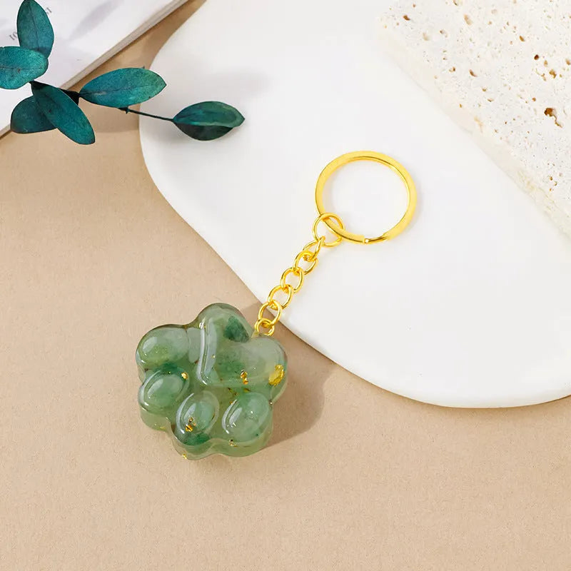 Small handcrafted crystal cat's paw shaped keychain pendant on a keyring.