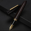 Wooden fountain pen with a rotating cap on a wooden desk, showing choice of rosewood and ebony bodies with different nibs.