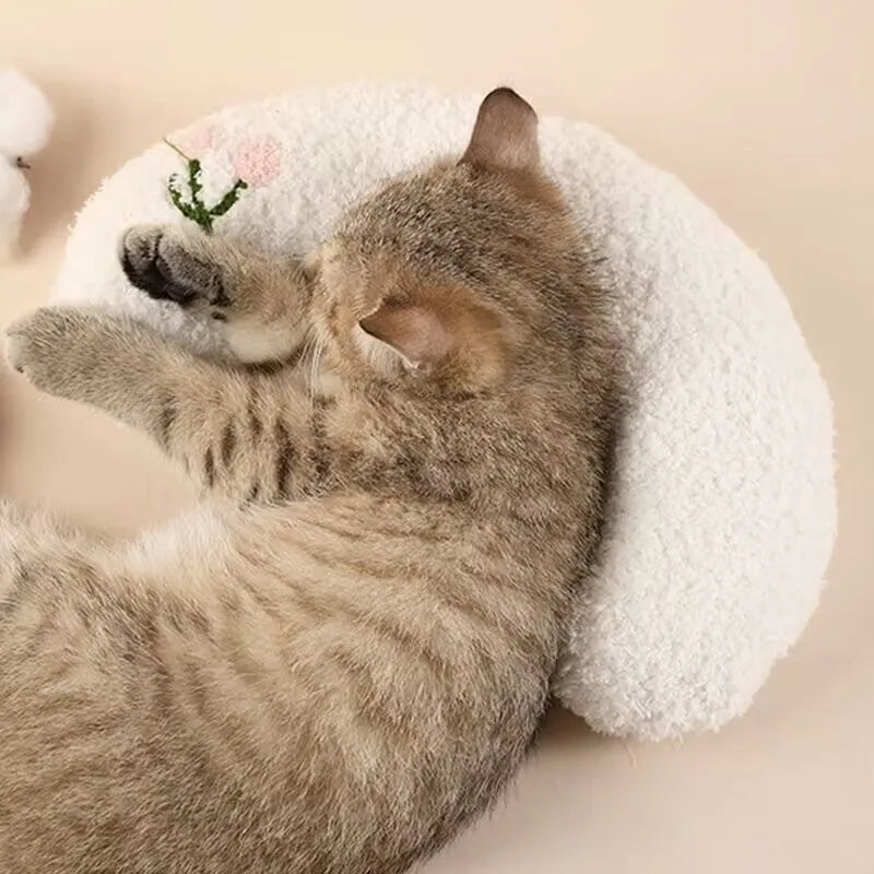 Blue U-shaped cat pillow with neck support in a question mark shape on a white background.