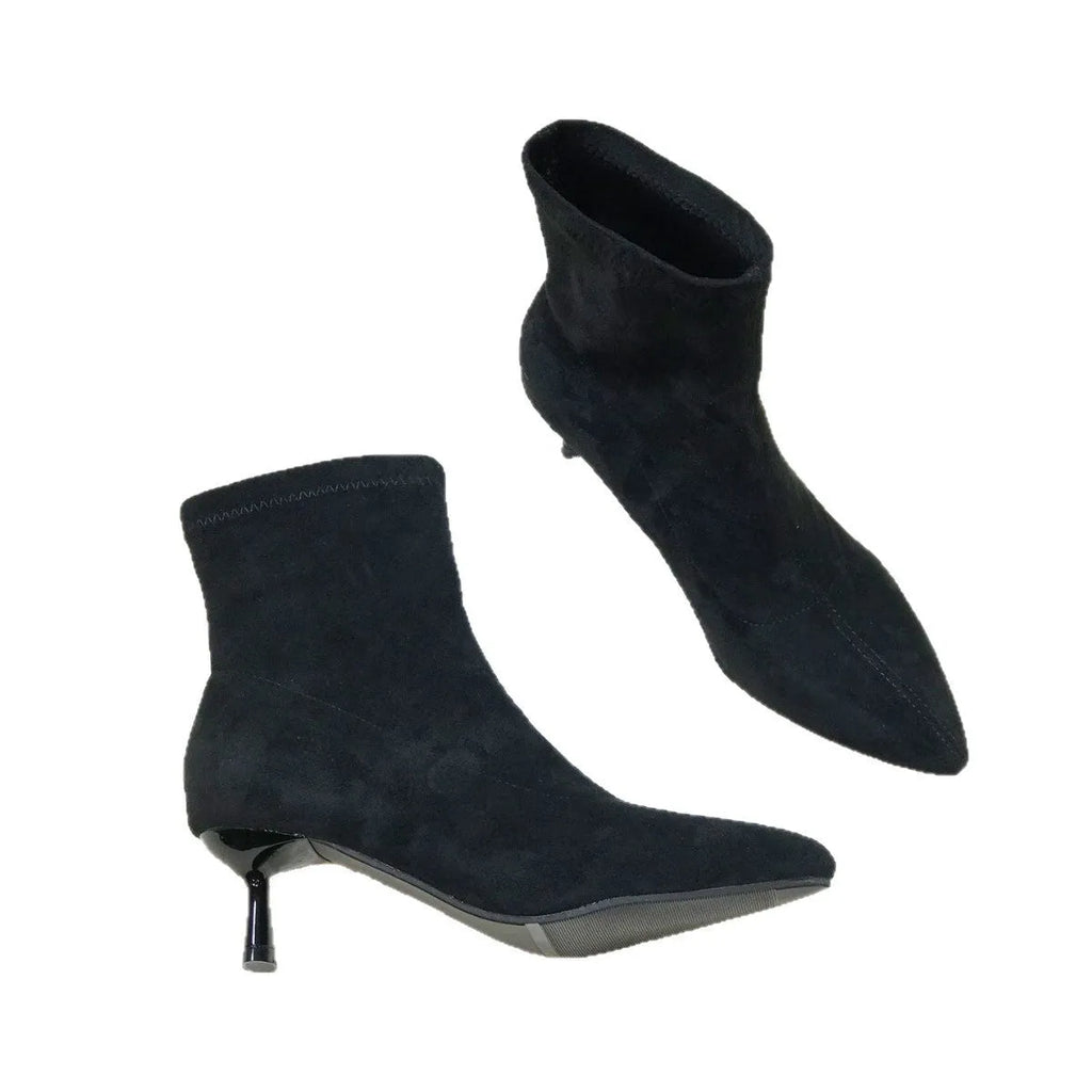 Women's black pointed toe ankle boots with stiletto heel and mid-calf length