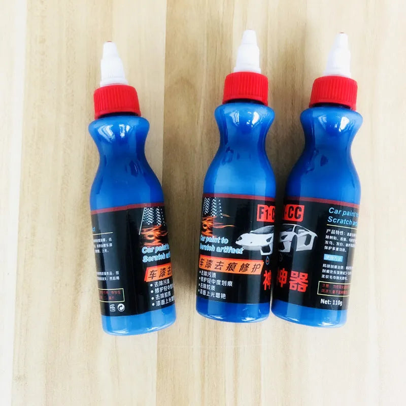 Blue car scratch repair kit with bottle of repair agent and application tool for automotive paint touch-ups