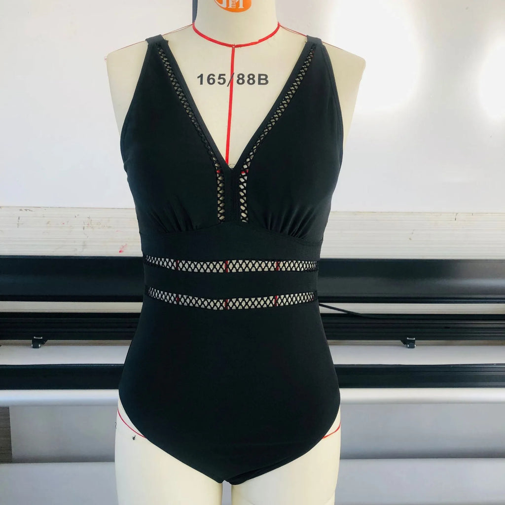 Black printed plus size women's bikini swimsuit on a hanger.