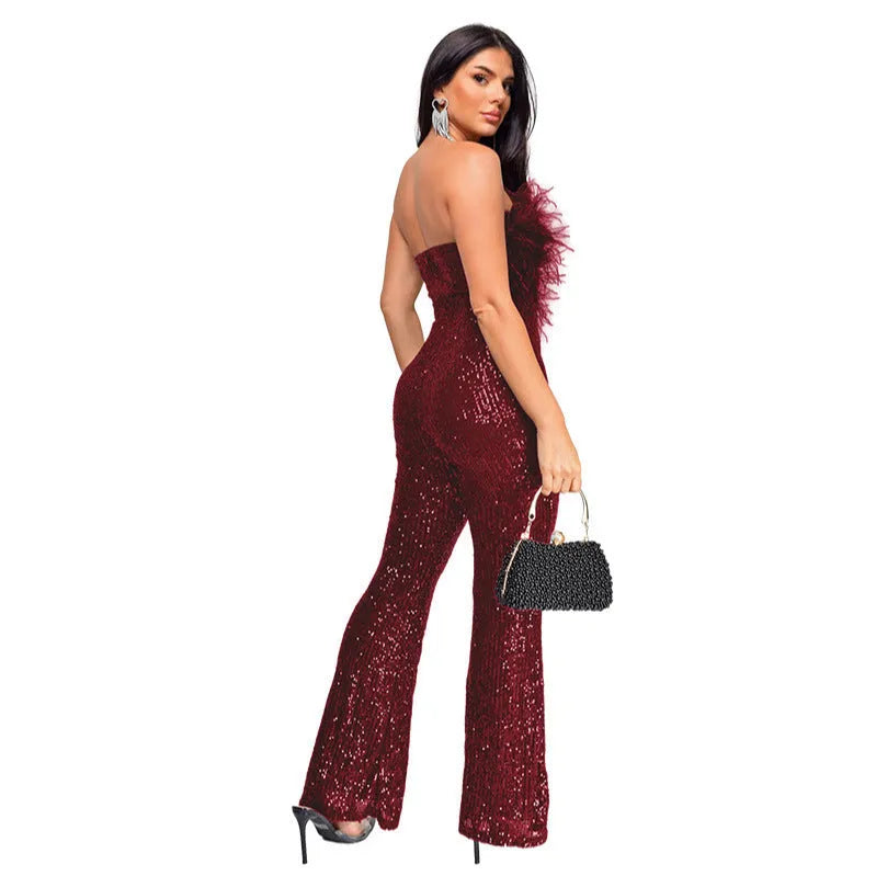 Women's black sleeveless backless jumpsuit with flared legs and sequin detail.