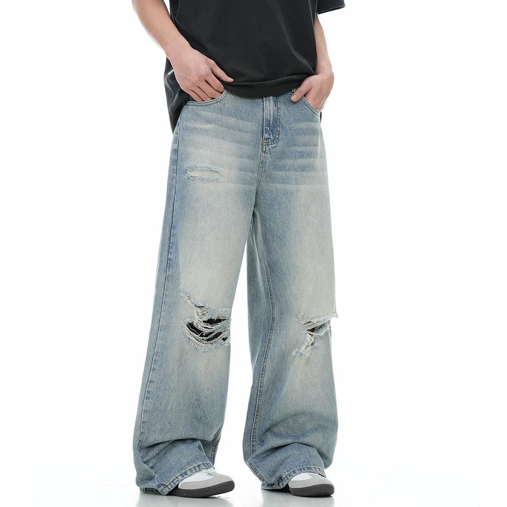Blue men's straight-leg ripped jeans on a plain background showing cotton blend fabric and zipper fly.