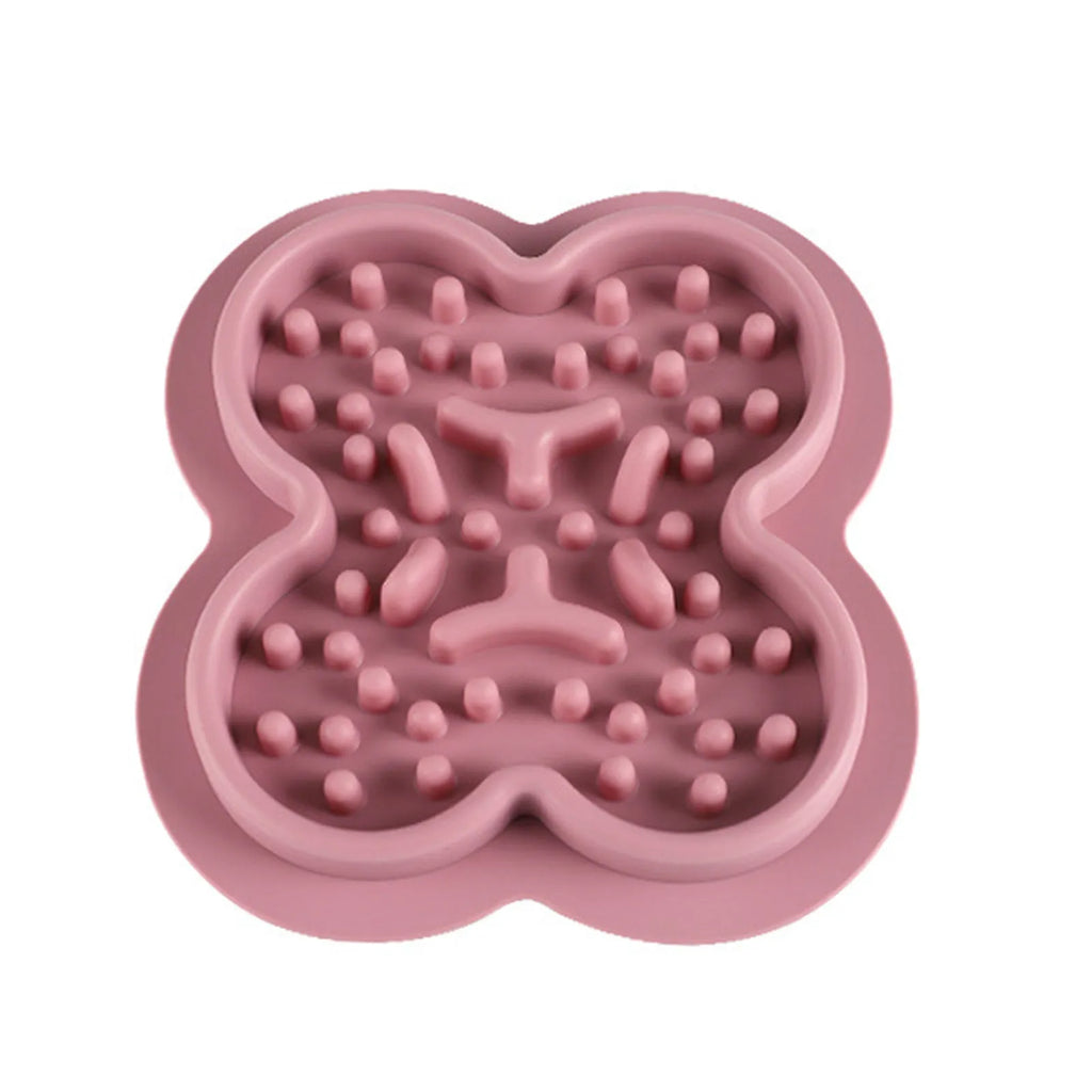 Silicone pet slow feeder licking pad mat in blue colour on a wooden floor.