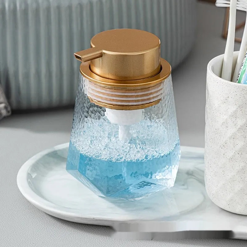 Foam pump dispenser with large head in metallic gold finish for facial cleansers and shower gels