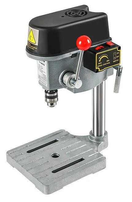 Mini bench drill and milling machine on a workbench with cross bench pliers.