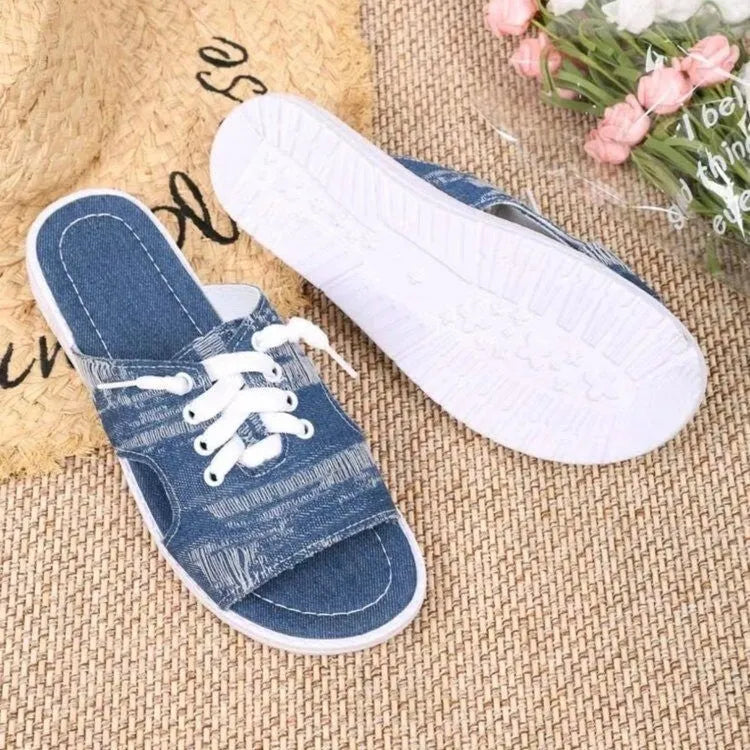 Blue Roman style women's canvas slippers with rubber sole and cloth lining displayed flat