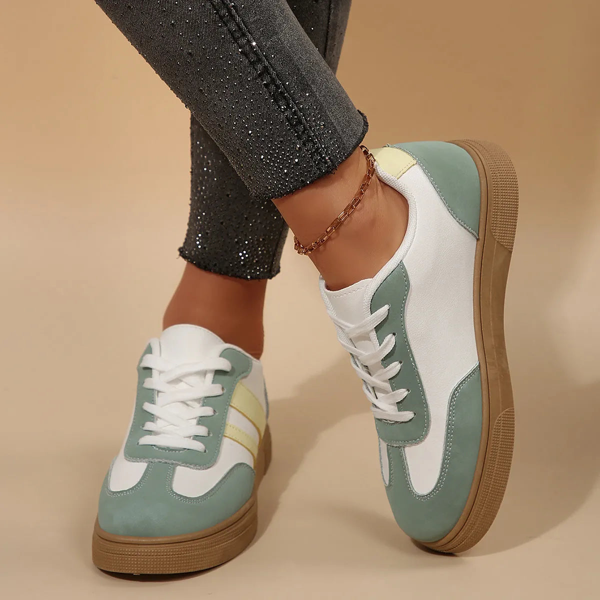 Green women's low-top casual pumps with cross-strap design and flat rubber sole.