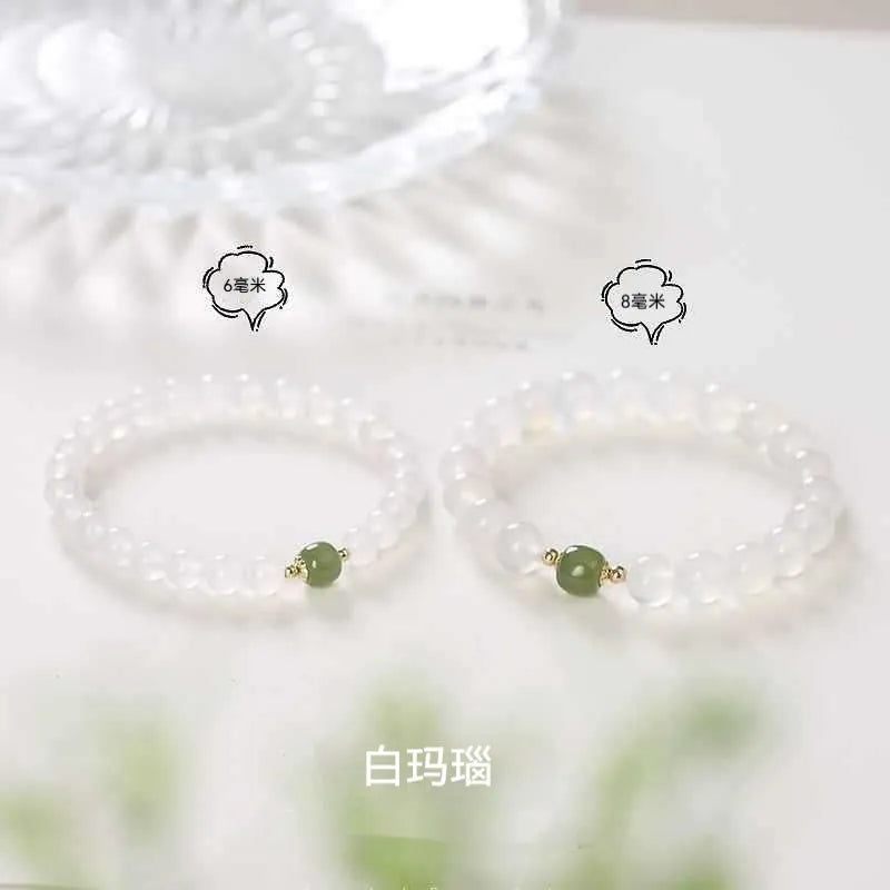 Handmade white agate and cinnabar crystal bracelet showing bead detail and inlay work