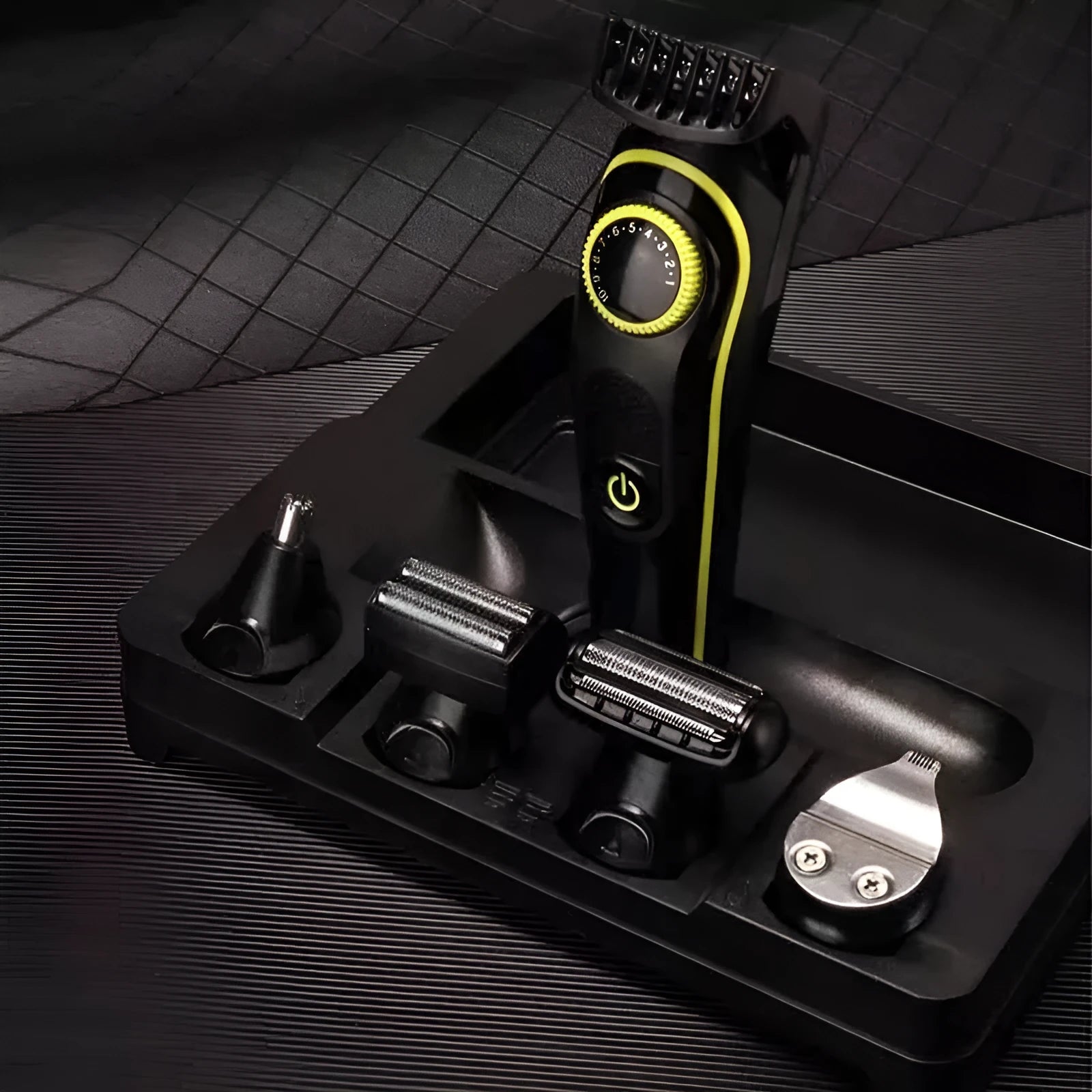 Black KM-696 rechargeable electric hair clipper set with stainless steel blades on a white background.
