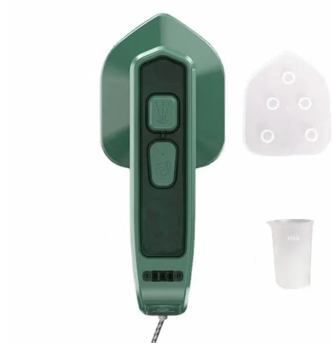 Dark green portable handheld steam iron with ceramic panel, shown next to clothing on a hanger.