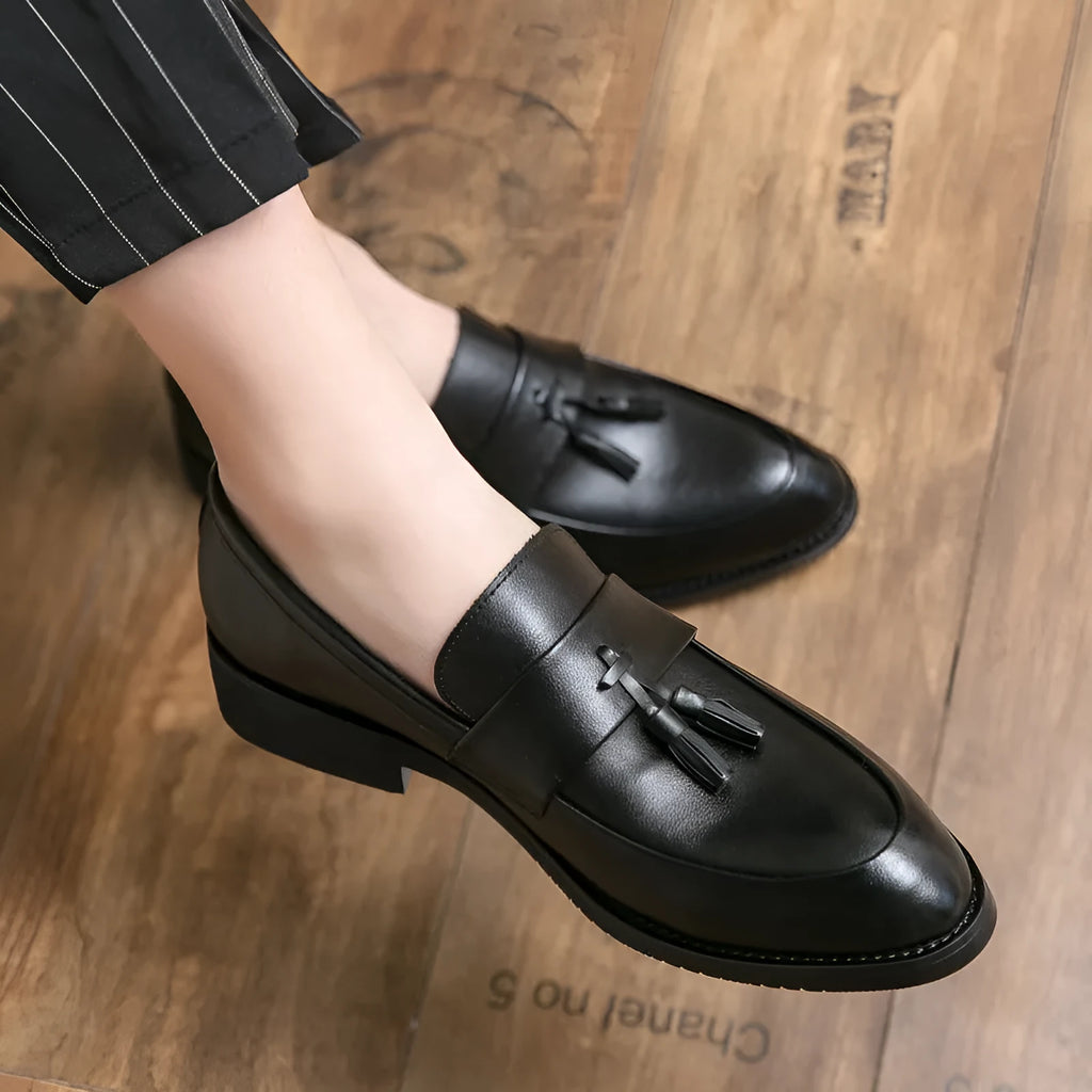 Men's black slip-on business casual shoes with tassel detail and rubber sole
