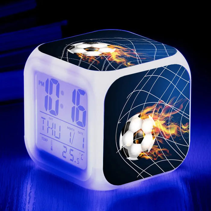 Square cartoon alarm clock with a football pattern design, showing a four-sided mute alarm for children.