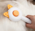 Self-cleaning cat grooming comb with stainless steel pins and rubber massage nodules in greenish white colour