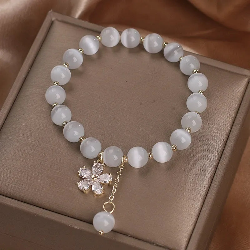 Women's white cat's eye stone bracelet with floral tassel and safety buckle clasp