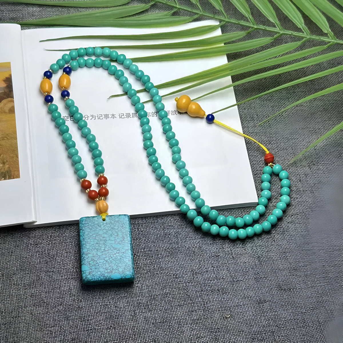 Turquoise mesh flower lucky pendant on ball bead chain necklace, hand-woven construction