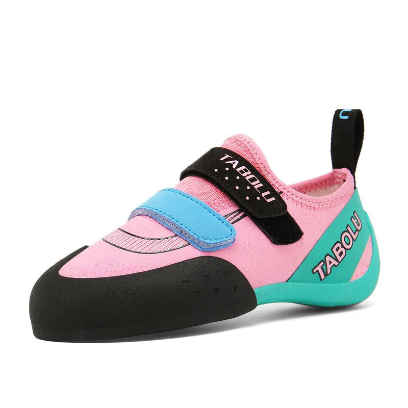 Beginner rock climbing shoes in black and red with Velcro strap and rubber sole.