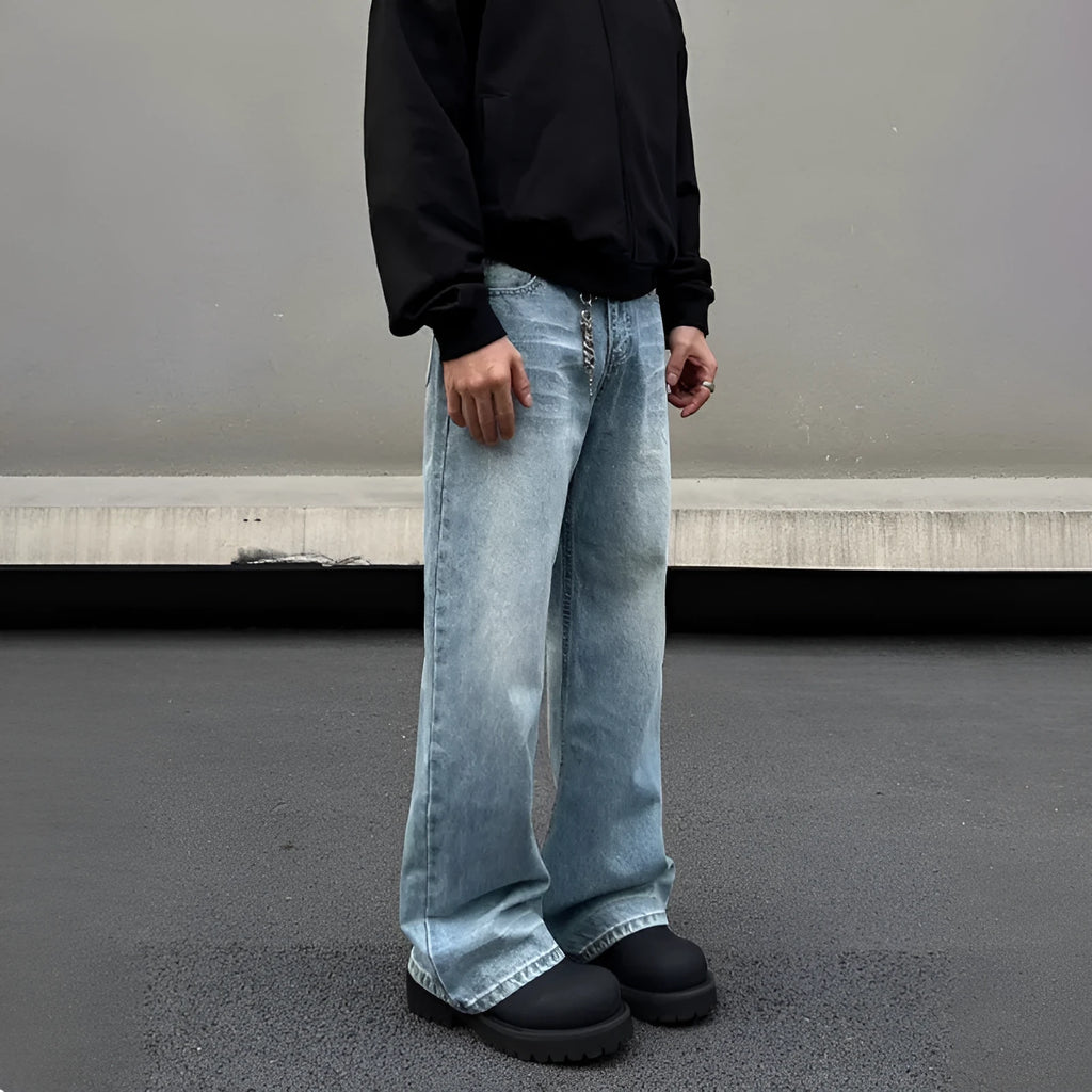 Men's blue retro straight-leg jeans with whisker washing detail on the thighs, showing a flared wide-leg cut.