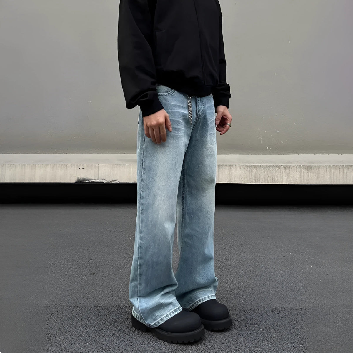 Men's blue retro straight-leg jeans with whisker washing detail on the thighs, showing a flared wide-leg cut.