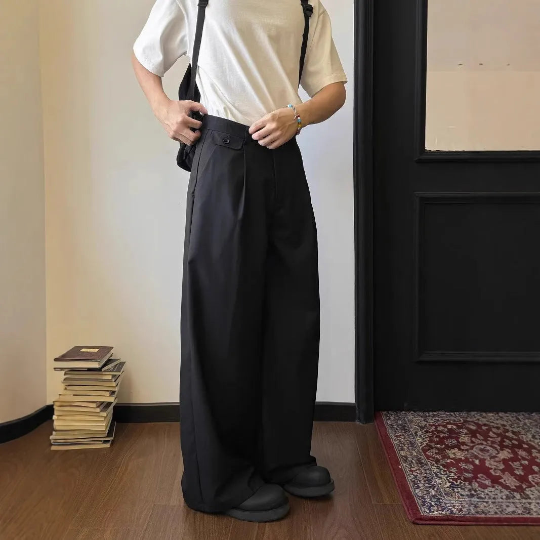 Men's loose-fitting straight-leg trousers in brown and black colours on a hanger
