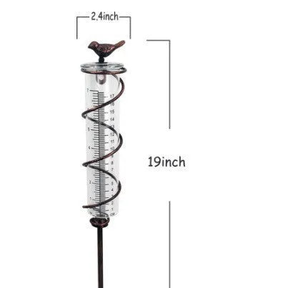 Cast iron hummingbird garden rain gauge with glass tube showing water measurement scale.